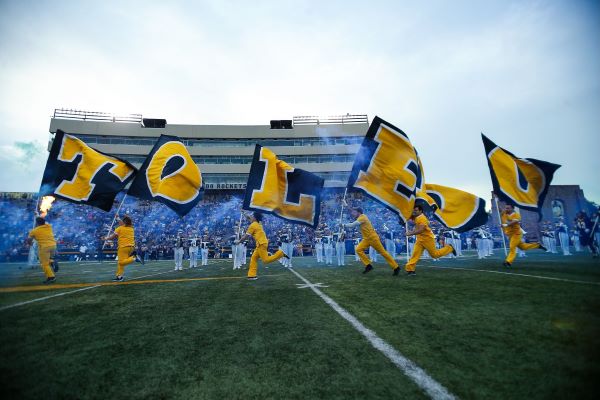 "TOLEDO" flags being ran across the football field